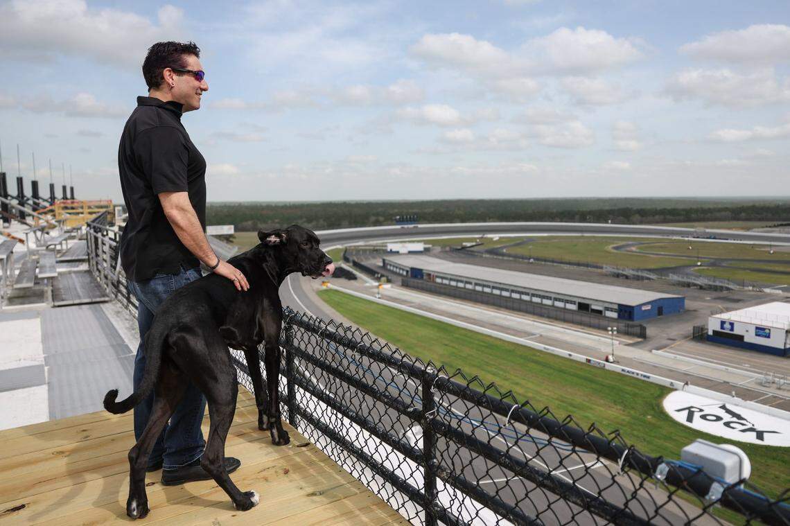 Dan Lovenheim and his dog, a 2½-year-old black Great Dane named Cub, stand on the roof of Rockingham Speedway on Monday, March 31, 2025. Since 2018 Lovenheim has owned the 250-acre raceway space that will welcome back racing the weekend of April 19.