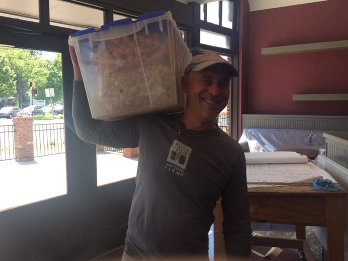 Sammy Koenigsberg of New Town Farm in Waxhaw, a longtime supplier for The Heritage, arrives with the first box of vegetables for The Stanley kitchen.