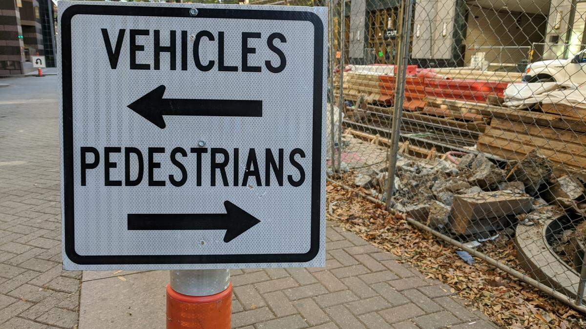 Signs direct traffic and pedestrians at Charlotte Mariott City Center on Trade Street where crews are working on the CityLynx Gold Line.