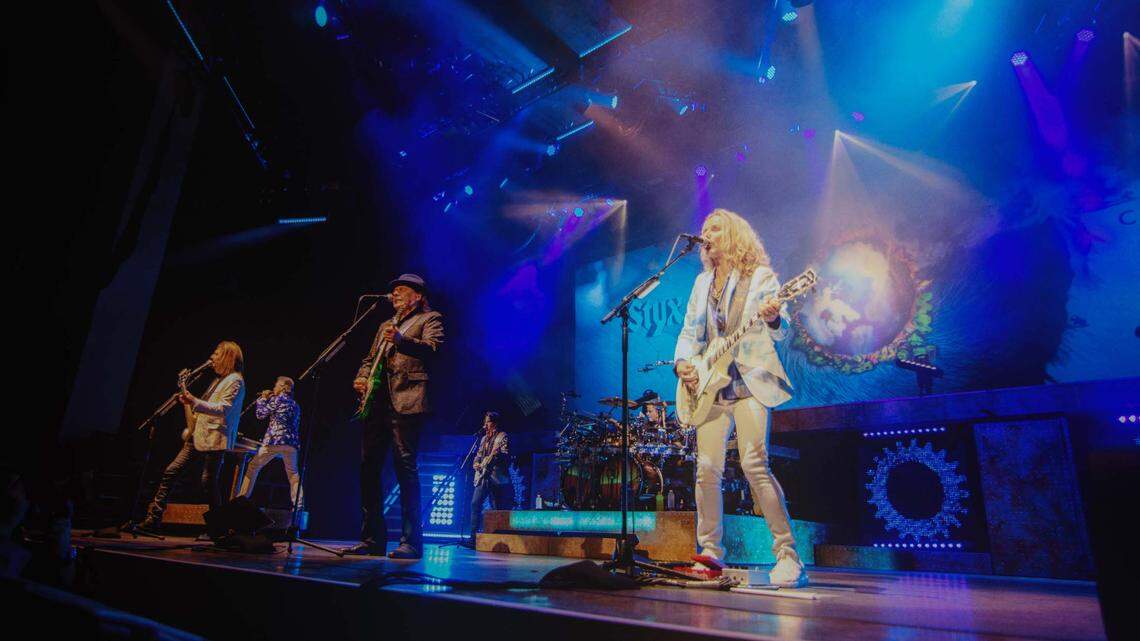 Styx vocalist and guitarist Tommy Shaw (right) leads his bandmates during their performance Saturday, Aug. 6, 2022, at PNC Music Pavilion in Charlotte.