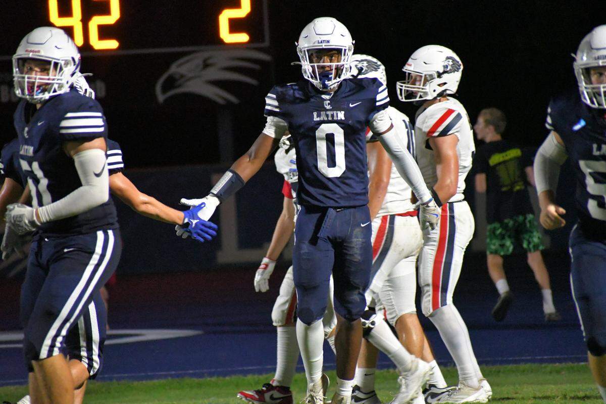 Charlotte Latin’s Titus Ivory is congratulated after a big play against Covenant Day Wednesday