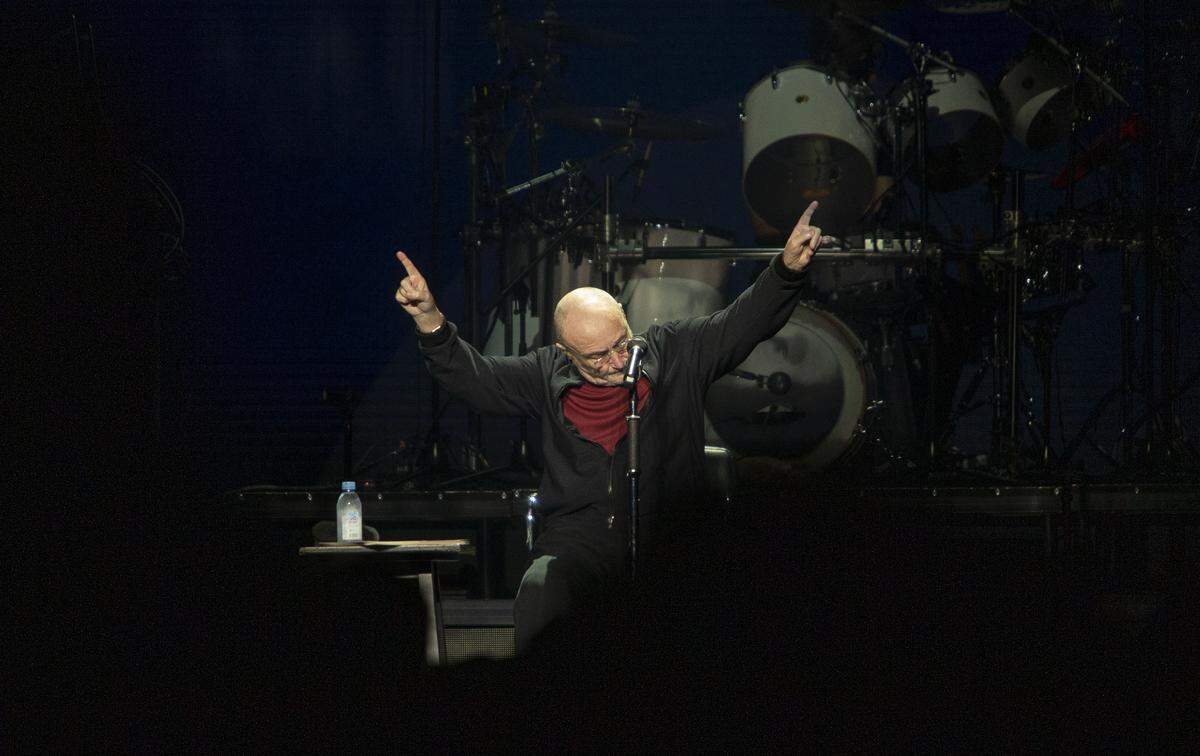 Phil Collins strikes a pose after finishing a song at the Spectrum Center in Charlotte on Sunday, September 29, 2019.
