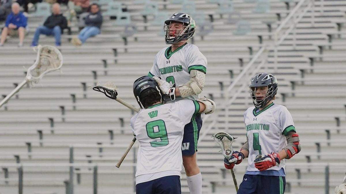 Weddington’s Ryan Kazella (being lifted) is The Charlotte Observer boys lacrosse player of the year.