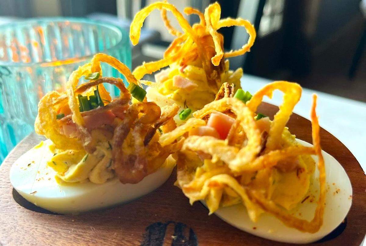 On the Nines Bistro’s deviled eggs feature Virginia ham, black truffle, smoked salt and crispy shallots.
