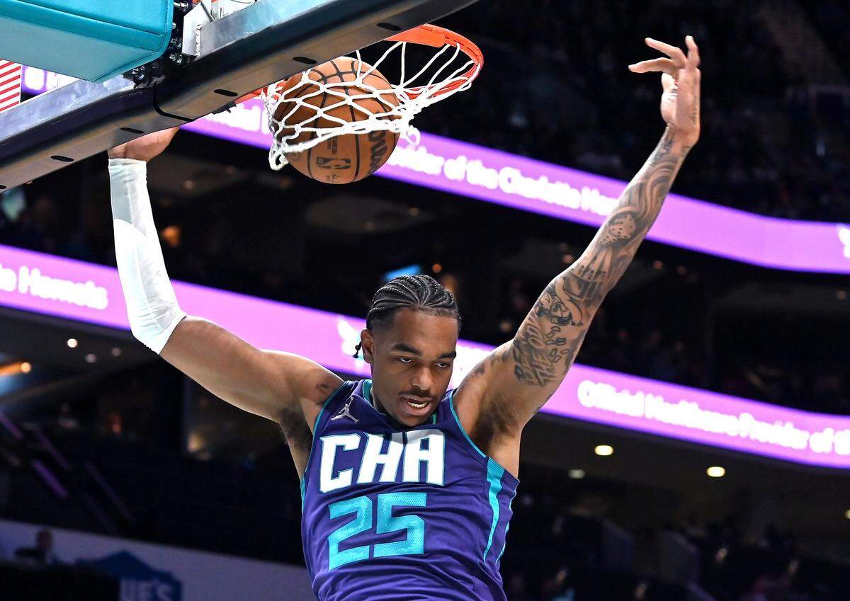 Charlotte Hornets forward PJ Washington finishes off a two-handed dunk off a pass from guard LaMelo Ball during first half action against the Washington Wizards at Spectrum Center in Charlotte, NC on Sunday, April 10, 2022.