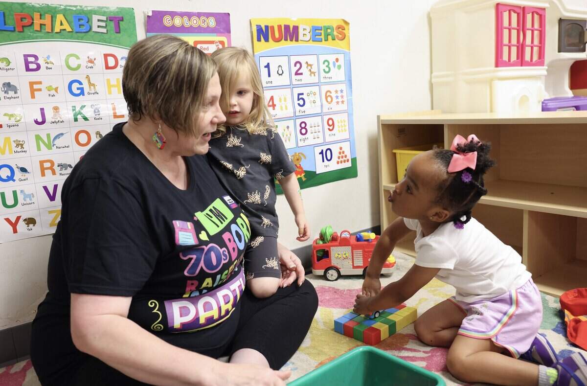 Emma Biggs, left, director of Pathway Preschool Center in Charlotte, plays with children at the center on Friday, May 22, 2026.