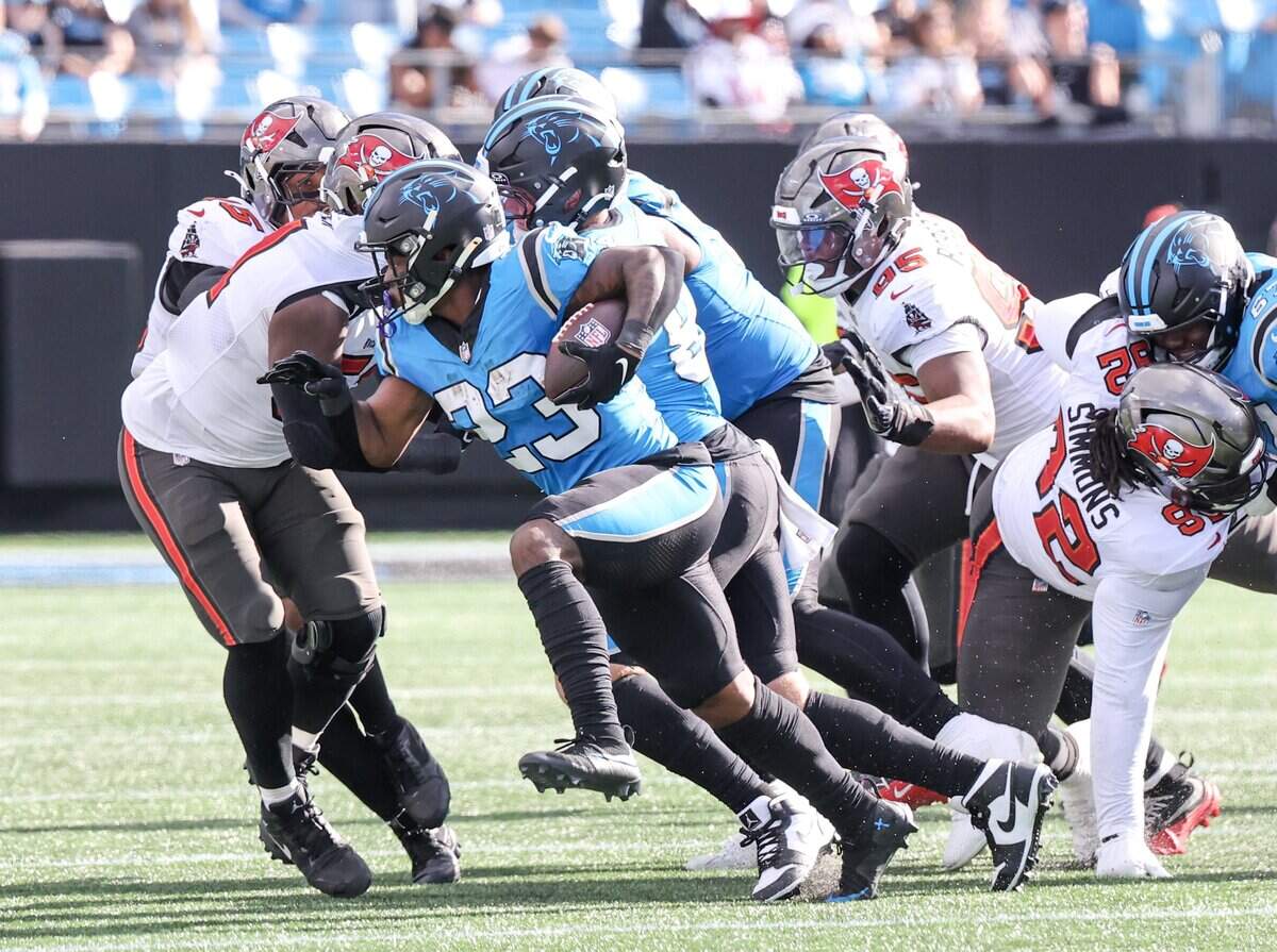 Carolina Panthers running back Trevor Etienne carries the ball as Tampa Bay Buccaneers defenders close in during the game at Bank of America Stadium on Sunday, Oct. 25, 2026 in Charlotte.