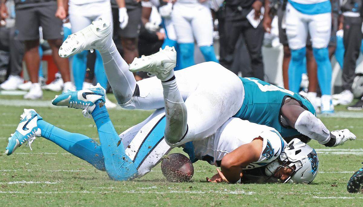 Carolina Panthers quarterback Bryce Young fumbles the ball as he is hit by Jacksonville Jaguars linebacker Foyesade Oluokun in Week 1 at Everbank Stadium in Jacksonville, Florida. The Jaguars would recover the ball and defeat the Panthers, 26-10.
