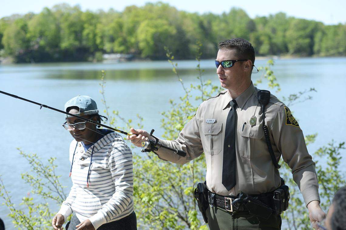 Cierra Hicks, had just bought a fishing license and new fishing gear for her first time ever fishing trip. But Hicks needed help untangling the line on her new reel and got it from N.C. Wildlife Resources Commission officer Sampson Parker, Jr. Parker says being a people person is one of the most important things when working in a county of more than one million people.