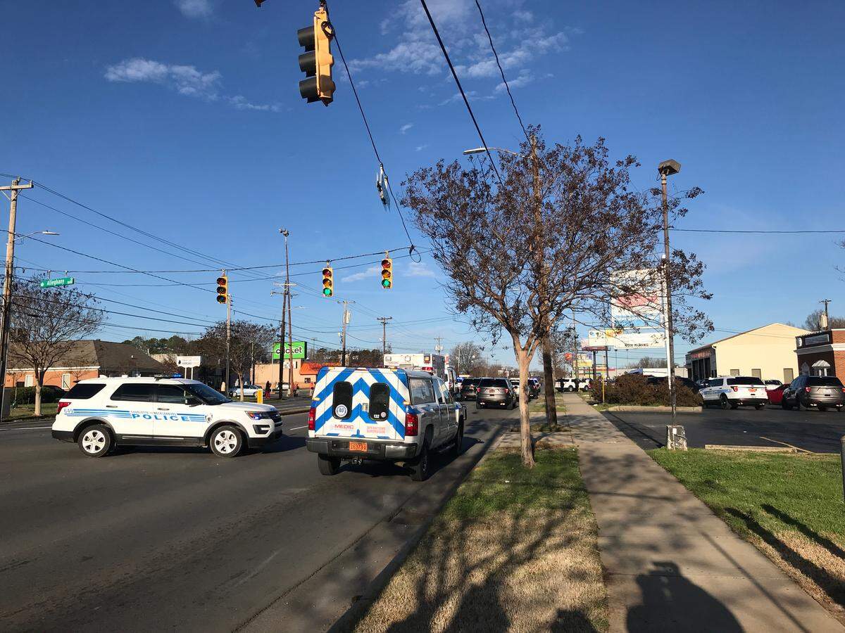 A stretch of Freedom Drive is shut down as Charlotte Mecklenburg Police investigate a lone gunman inside an Advanced Auto Parts store. 