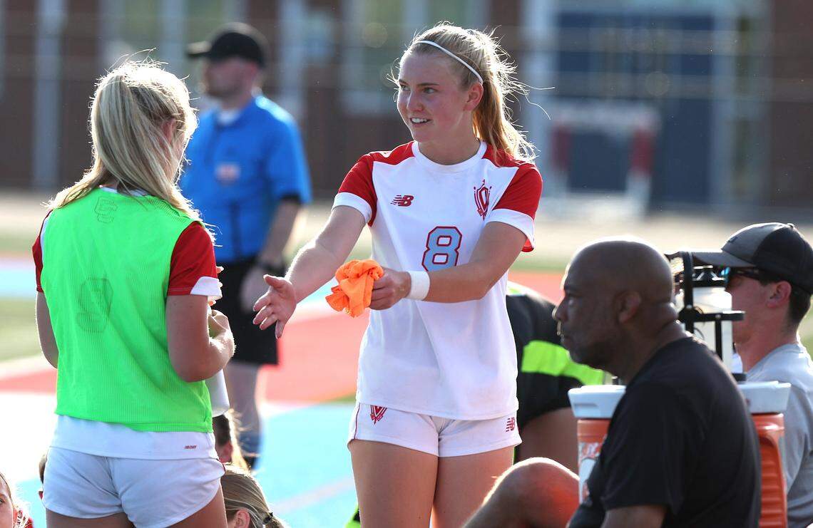Charlotte Catholic’s Mary Martin Spinner, center, talks with a teammate along the sideline during action against Piedmont on Wednesday, April 15, 2026. Charlotte Catholic is ranked No. 4 in the nation by MaxPreps.
