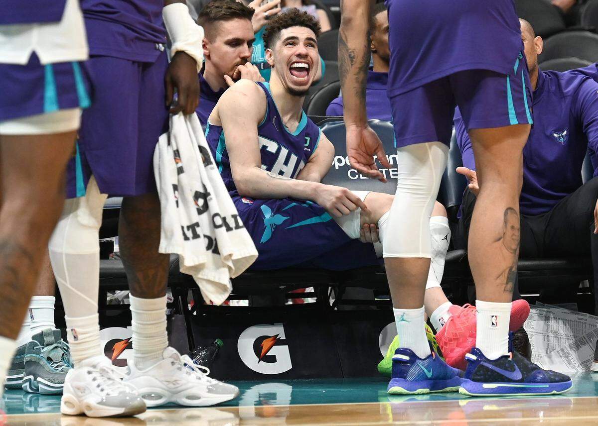 Charlotte Hornets guard LaMelo Ball laughs at forward Miles Bridges as the team celebrates their play against the Washington Wizards on Sunday, April 10, 2022 at Spectrum Center in Charlotte, NC. The Hornets defeated the Washington Wizards 124-108. Ball scored 24 points in the game and had 10 rebounds and nine assists.