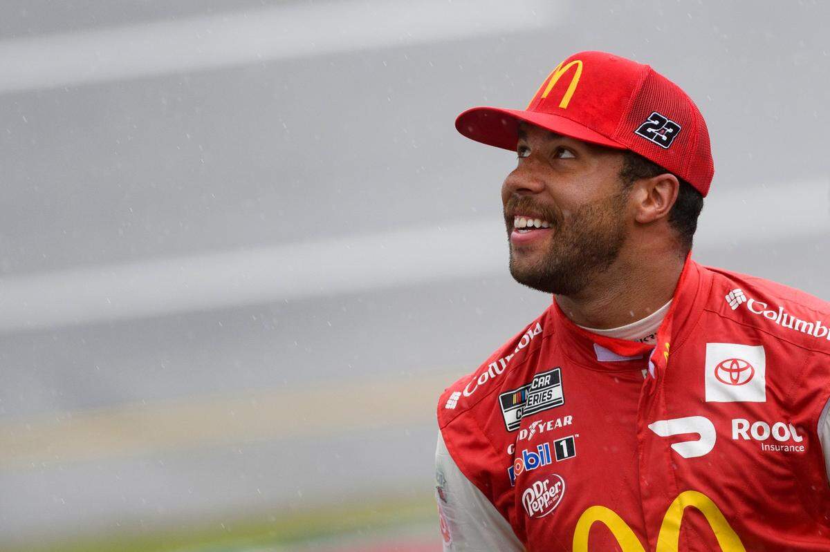 Bubba Wallace looks toward the clouds during a rain delay in a NASCAR Cup series auto race in which he later won Monday, Oct. 4, 2021, in Talladega, Ala. (AP Photo/John Amis)
