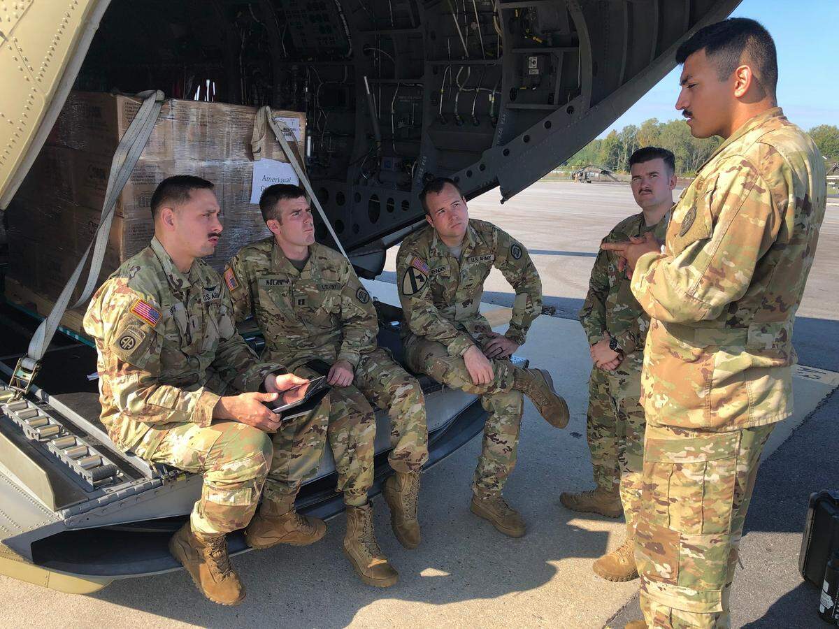 Pilot Carson Smith leads a briefing for members of his team prior to leaving for Western North Carolina on Thursday, October 3, 2024. The team was delivering supplies.