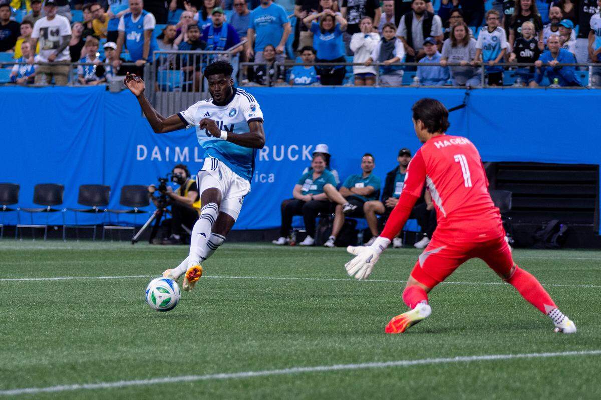 Charlotte FC forward Patrick Agyemang (33) shoots past Columbus Crew goalkeeper Nicholas Hagen (1) during Saturday’s first half at Bank of America Stadium.