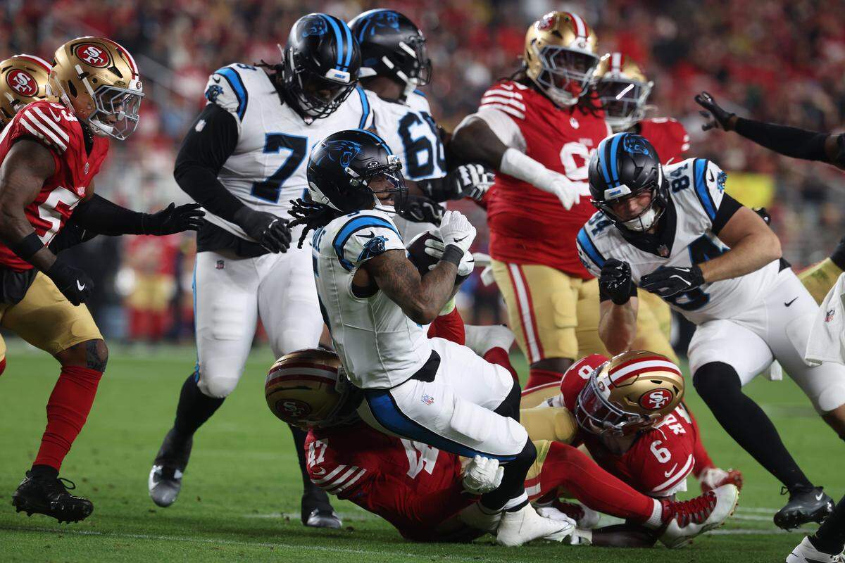 Rico Dowdle (5) of the Carolina Panthers is tackled by Bryce Huff (47) of the San Francisco 49ers in Monday’s second quarter at Levi's Stadium.