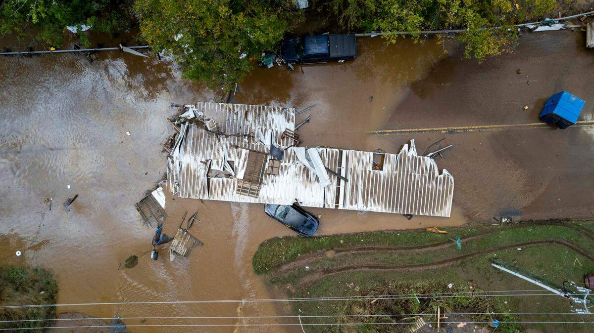 Part of a structure sits in floodwaters on a road in Canton on Friday, Sept. 27, 2024 as the remnants of Hurricane Helene caused flooding, downed trees, and power outages in western North Carolina.