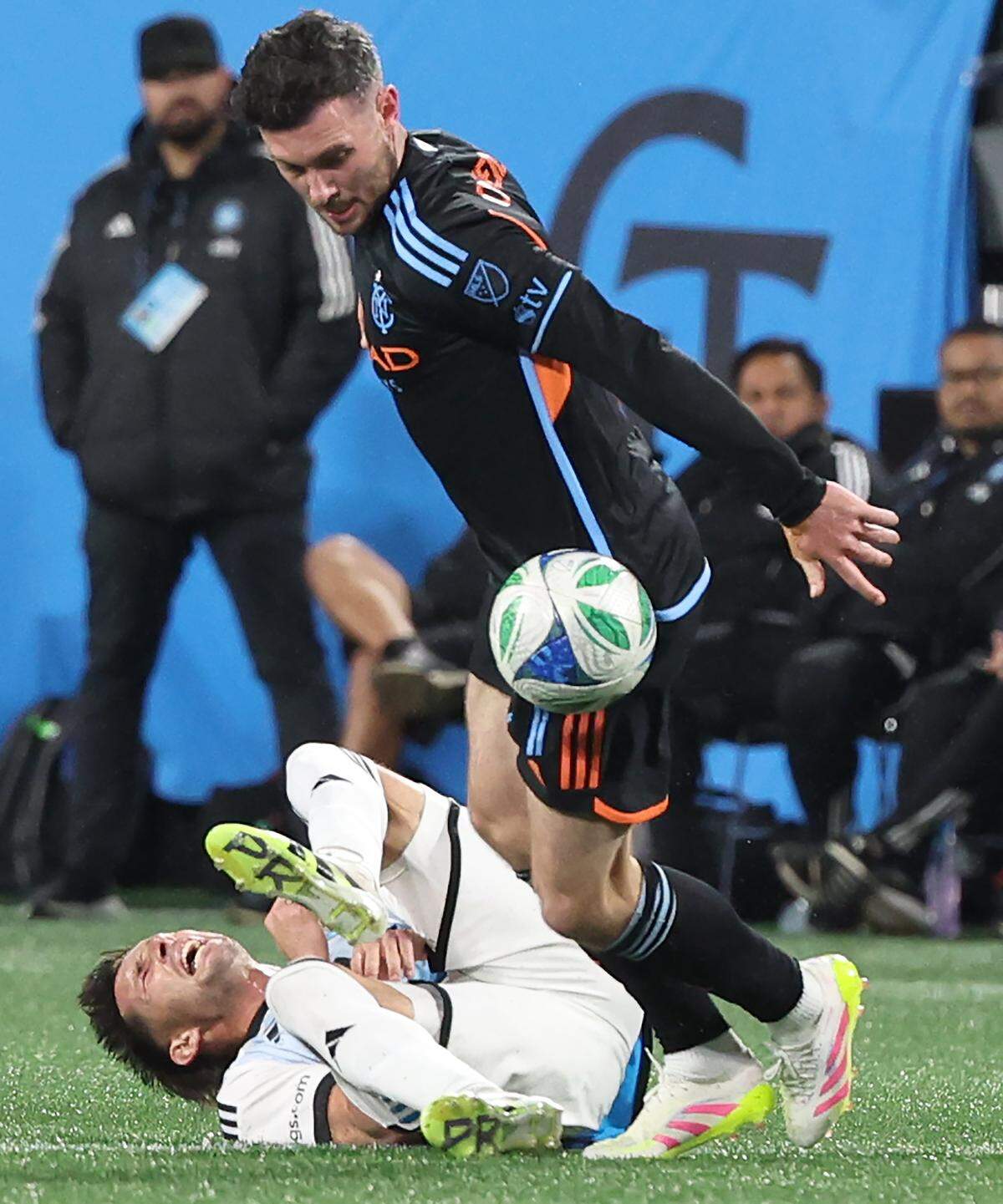 New York City FC central midfielder Aiden O'Neill, right, attempts to gain control of the ball as Charlotte FC central midfielder Brandt Bronico, left, falls to the pitch at Bank of America Stadium in Charlotte, NC on Tuesday, October 28, 2025.