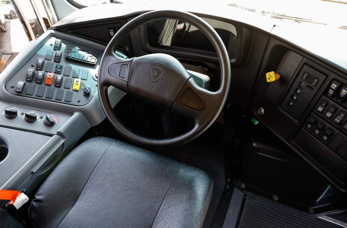 The driver’s seat inside an electric school bus.