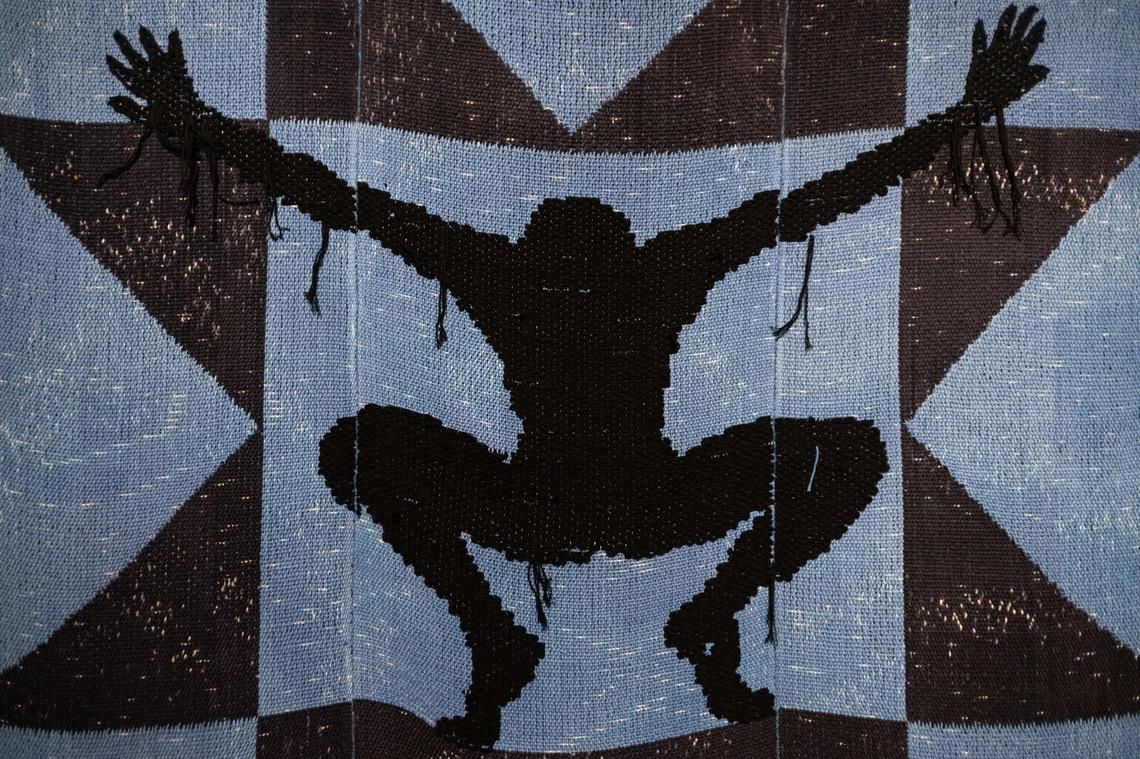 Diedrick Brackens cotton and acrylic yarn tapestry titled “survival is a shrine, not the small space near the limit of life,” hangs in the “Diedrick Brackens: ark of bulrushe”s exhibit at Mint Museum Randolph. The exhibit features works of textiles, basketry, and photography from Brackens addressing African American and queer histories with recurring images of Black bodies.