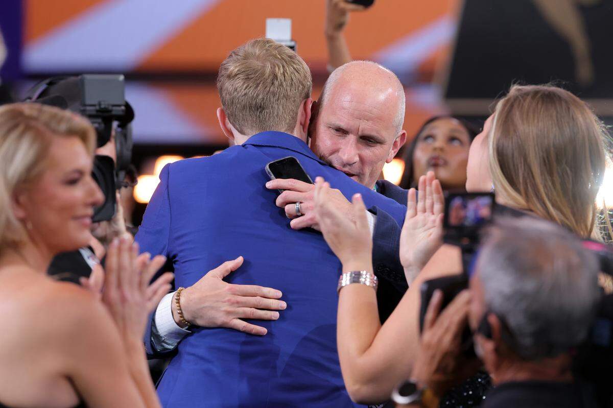 Liam McNeeley embraces Connecticut Huskies head coach Dan Hurley after being selected as the 29th pick by the Phoenix Suns in the first round of the 2025 NBA Draft at Barclays Center.