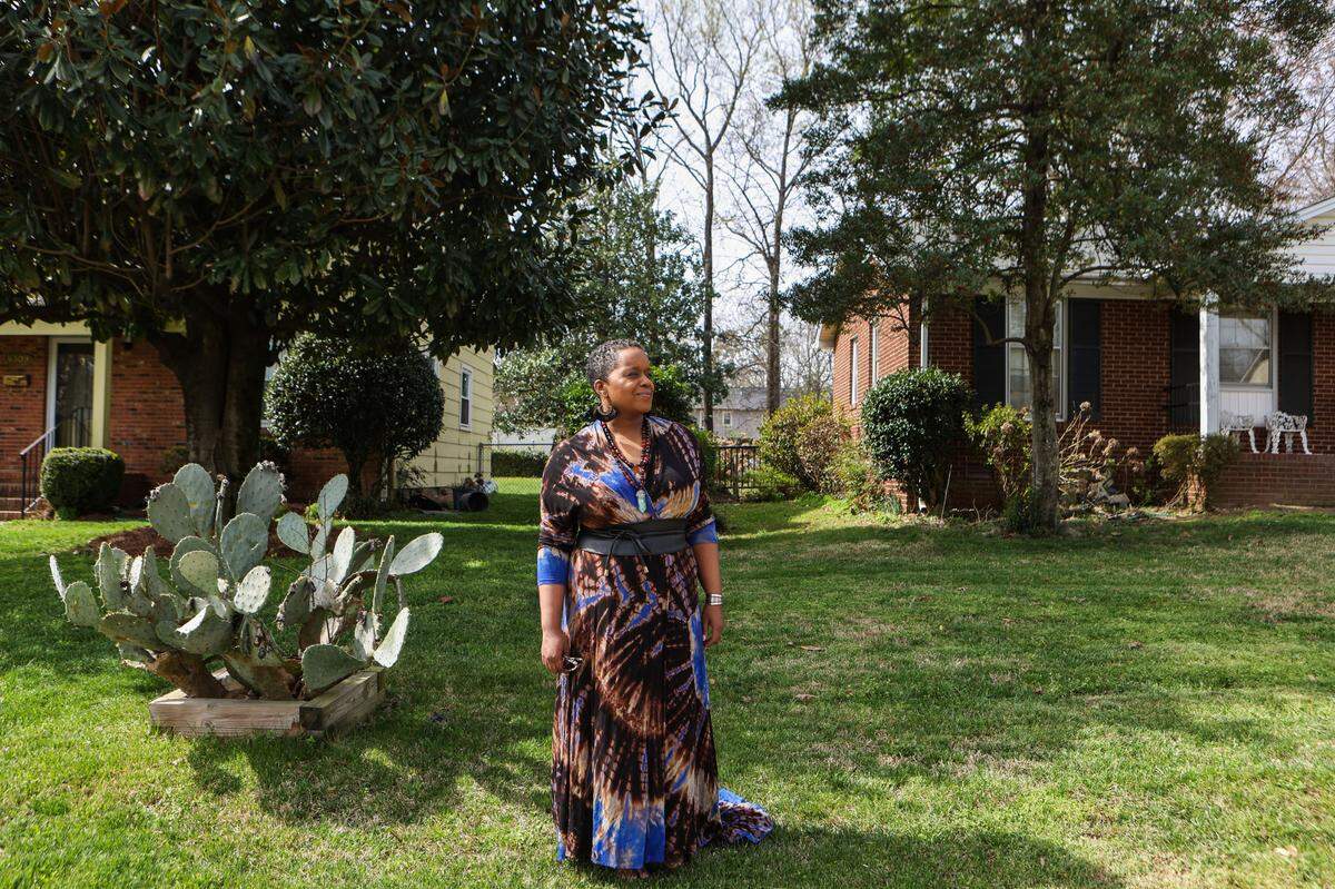 Ingrid Hoover stands between her parent’s home on the left and the home she purchased in 2019 on the right. Hoover’s home, located in the Hidden Valley community, used to belong to her childhood neighbor, Marion Manigault.