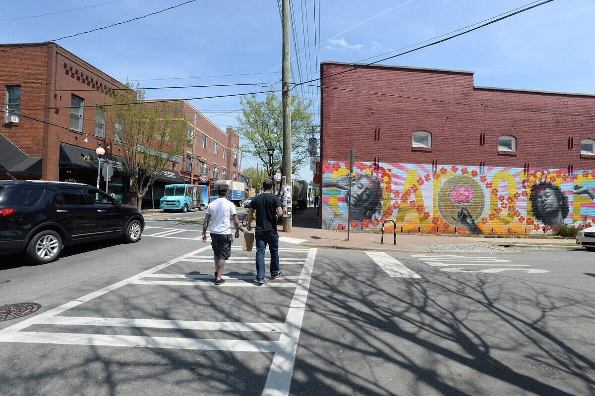 "People love it," said Teresa Hernandez, who owns Pura Vida Worldly Art. "People take pictures in front of it all the time. In NoDa people come to see the murals, but they don't expect to see one on a Dumpster."