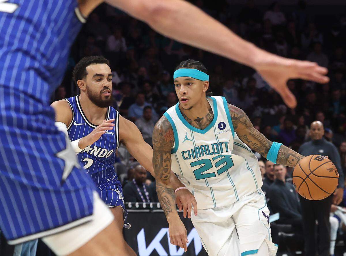 Charlotte Hornets guard Tre Mann, right, drives into the lane as Orlando Magic guard Tyus Jones, left, defends at Spectrum Center in Charlotte, NC on Thursday, October 30, 2025. The Magic defeated the Hornets 123-107.
