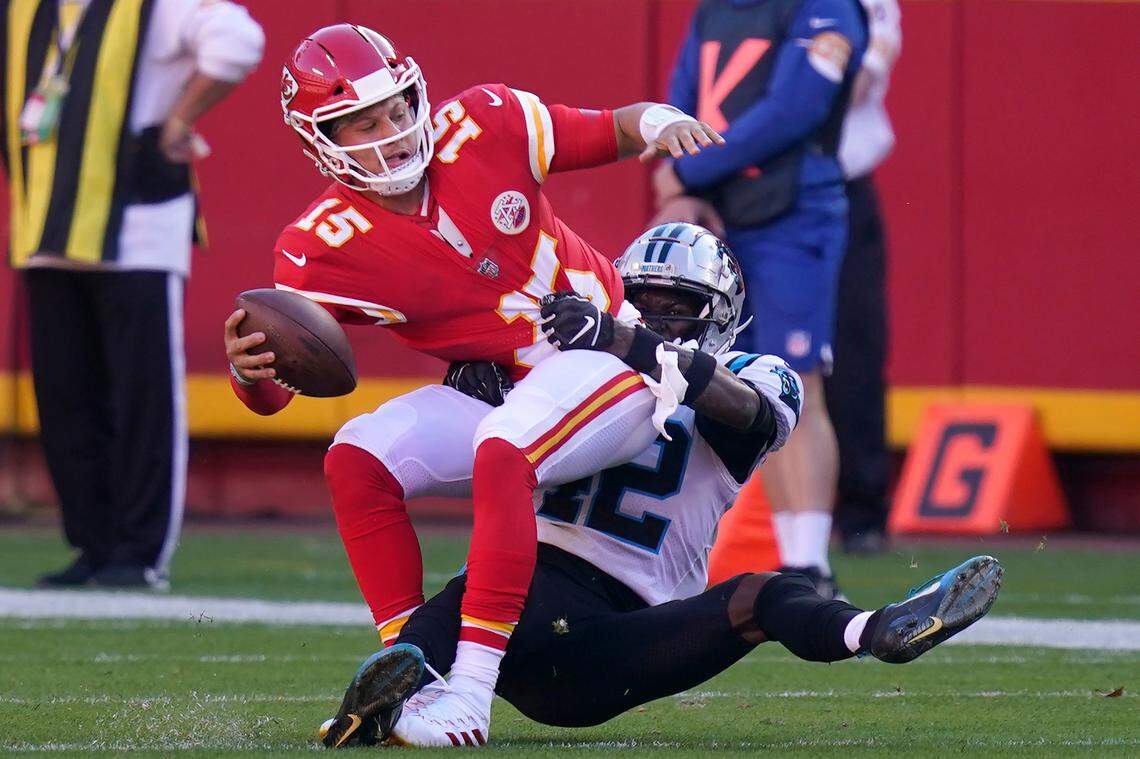 Kansas City Chiefs quarterback Patrick Mahomes, left, is sacked by Carolina Panthers safety Sam Franklin during the second half of an NFL football game in Kansas City, Mo., Sunday, Nov. 8, 2020. (AP Photo/Orlin Wagner)