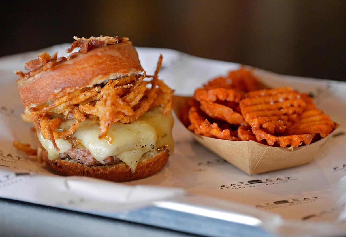 A Fat Frannie burger uses doughnuts instead of bread at Fat Cat Burgers + Bakeshop, formerly Fran’s Filling Station, in Dilworth.