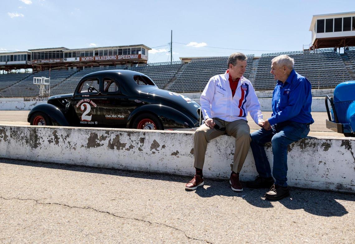 Gov. Roy Cooper talks with Dink Widenhouse after a speech at the Historic North Wilkesboro Speedway in Wilkesboro, NC on Tuesday May 17, 2022. Widenhouse would race throughout North CarolinaÕs dirt tracks and only raced North Wilkesboro once. He was able to get a pole position in qualifying although finished 19th in the race. The speedway has not hosted a race for many years but was once common stop for early racing in the Carolinas before it evolved into NASCAR. Federal money given to North Carolina will go towards the revitalization of the speedway and will be a catalyst for other events in Wilkes county.