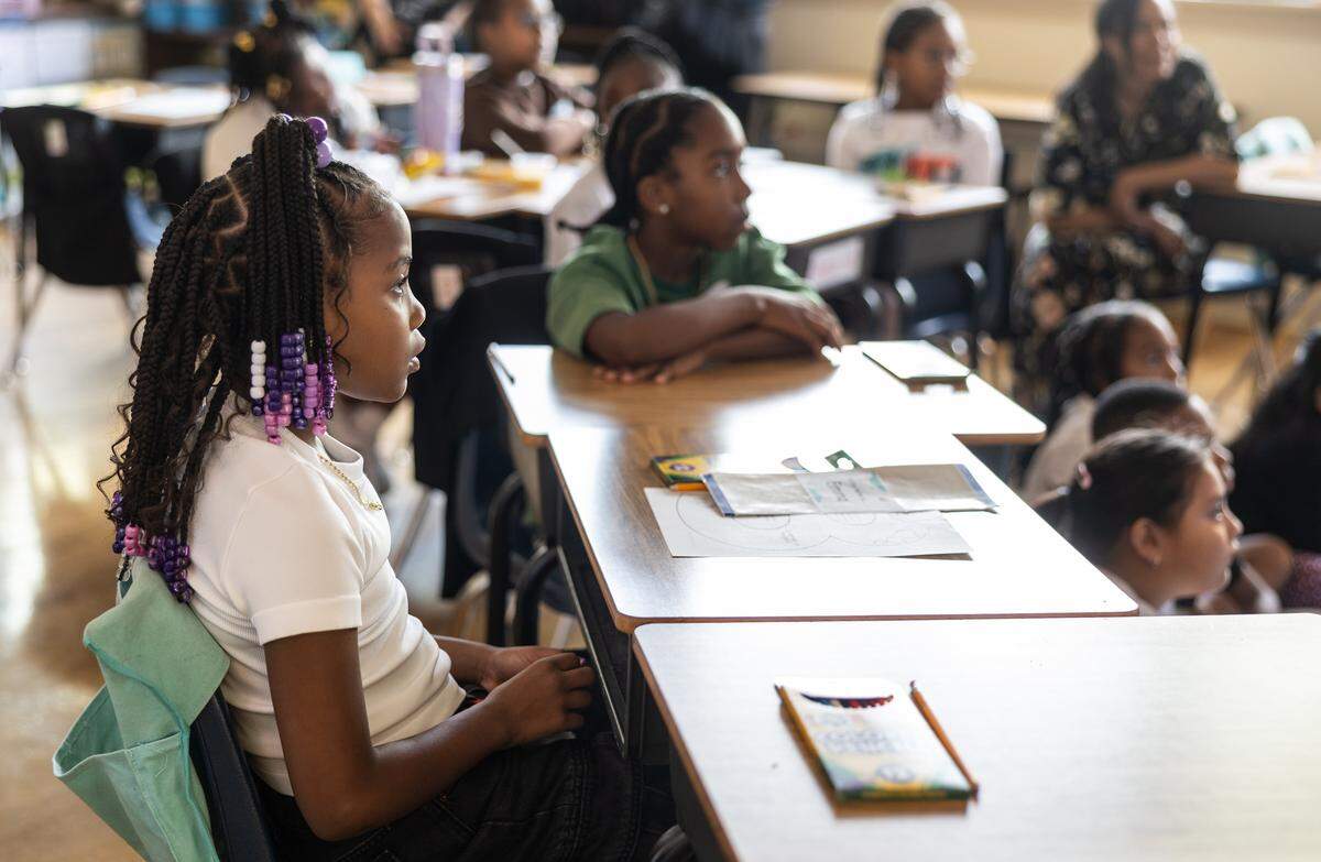Students get started on their first lesson of the day during the first day of school at Elizabeth Traditional School in Charlotte, N.C., on Monday, August 25, 2025.