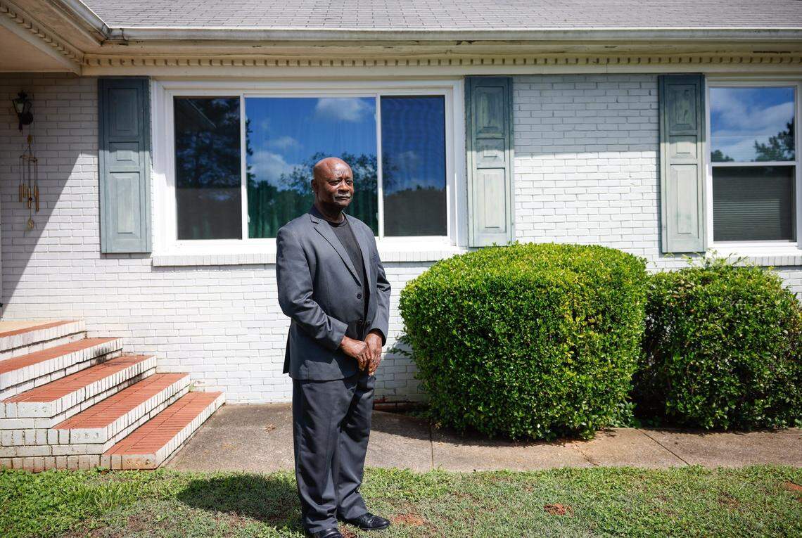 Terry Belk, shown here outside his east Charlotte home, says Atrium’s decision to cancel debt-collection liens is “going to alleviate a lot of stress for people.”