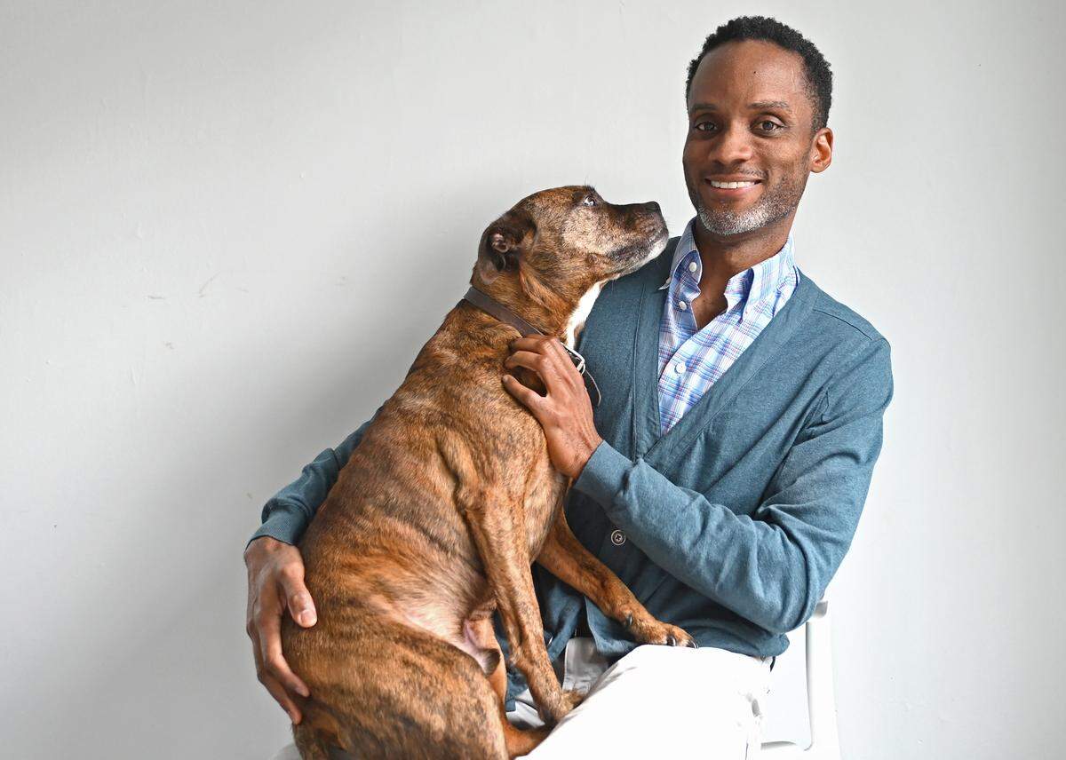 Sekou Cooke, shown here with dog Gizmo, is a Jamaican-born architect and UNC Charlotte urban design program director who arrived in 2021 after a seven-year stint as a professor at Syracuse University.