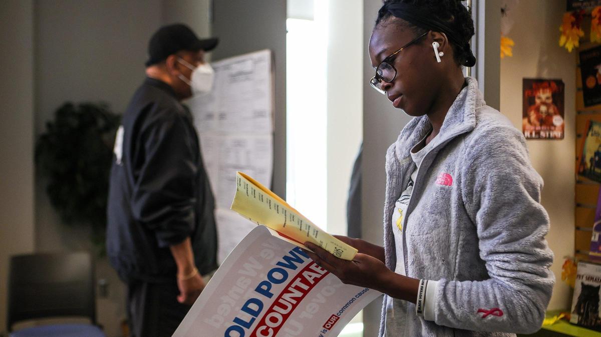 Jalliyah Cannady studies a sample ballot before voting at Allegra Westbrooks Regional Library on the first day of early voting on Thursday, October, 20, 2022.
