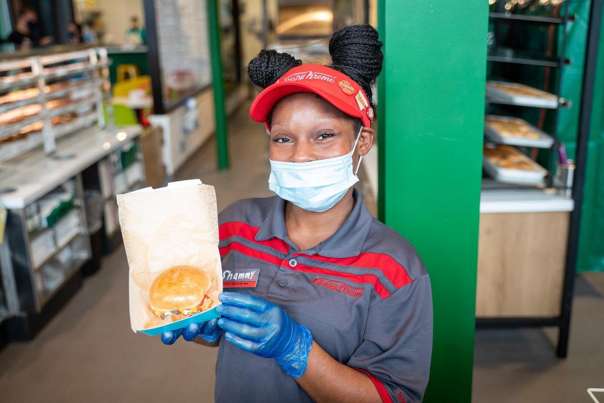 Shamonte Prater displays one of Krispy Kreme’s new ice cream sandwiches, called “scoop sandwiches.”