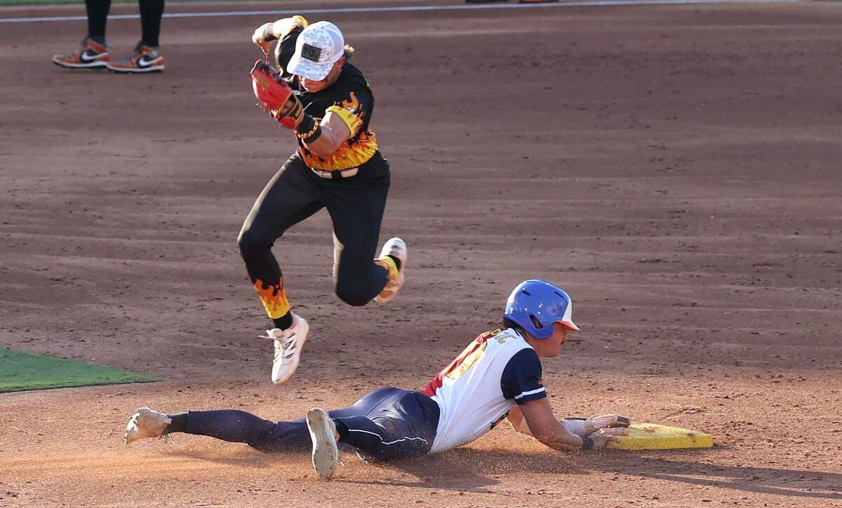 Texas Tailgaters Jacob Pipercic slides safely into second base as Firefighters Tyner Hughes secures the throw during action at Truist Field in Charlotte, NC on Thursday, June 4, 2026. Banana Ball action returned to the Queen City with the Texas Tailgaters battling the Firefighters.