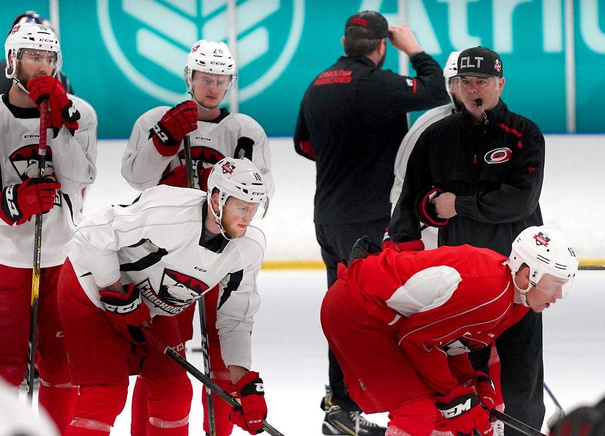 Charlotte Checkers head coach Mike Vellucci, right, said the noise at Bojangles’ Coliseum Sunday night during the Checker’s double-overtime win “gave me chills.”