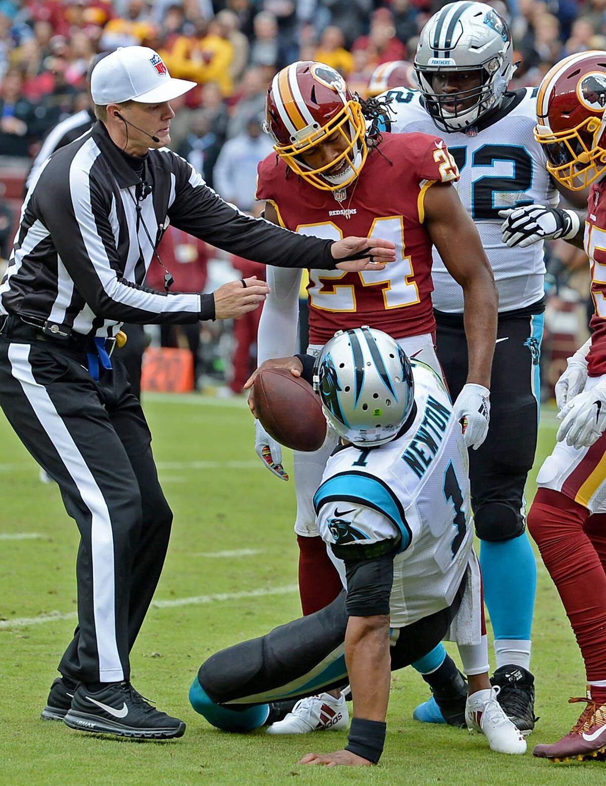 Washington cornerback Josh Norman stands over Carolina Panthers quarterback Cam Newton after Newton was tackled during thee fourth quarter on Sunday at FedEx Field in Landover, Md. Norman and Washington defeated the Panthers 23-17.