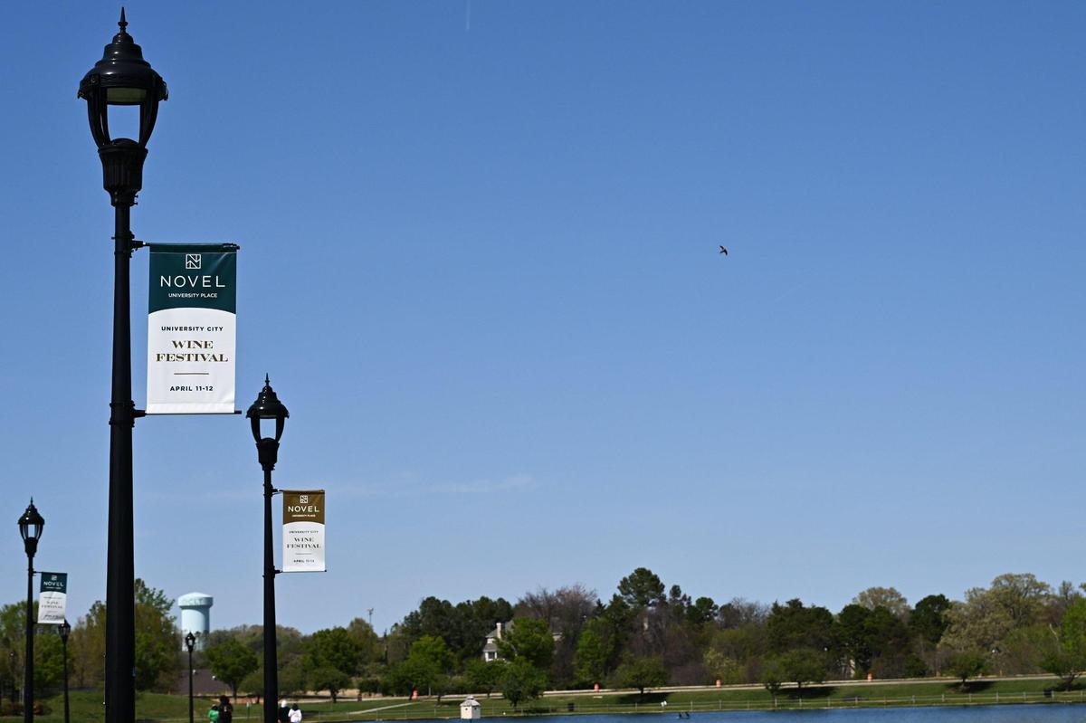 More banners and wayfinding will be added to the University lake boardwalk as The Shoppes at University Place become The Boardwalk at University City. The plaza is also getting a $5 million facelift.
