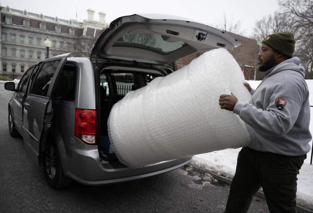 A National Park Service employee removes bubble wrap from a van at the White House in Washington, DC, on January 10, 2025. (Photo by ANDREW CABALLERO-REYNOLDS / AFP) (Photo by ANDREW CABALLERO-REYNOLDS/AFP via Getty Images)