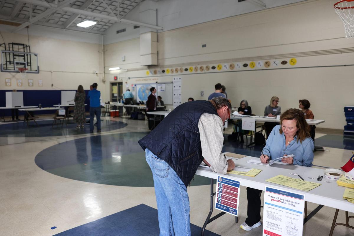 A voter checks in to vote at Eastover Elementary School in Charlotte, N.C., on Tuesday, November 7, 2023.