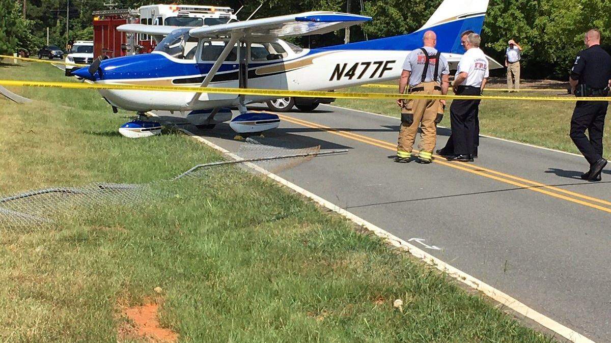 Two people flying a small plane in east Charlotte Sunday were not injured when they landed on a road instead of the Wilgrove Airport runway, officials said.