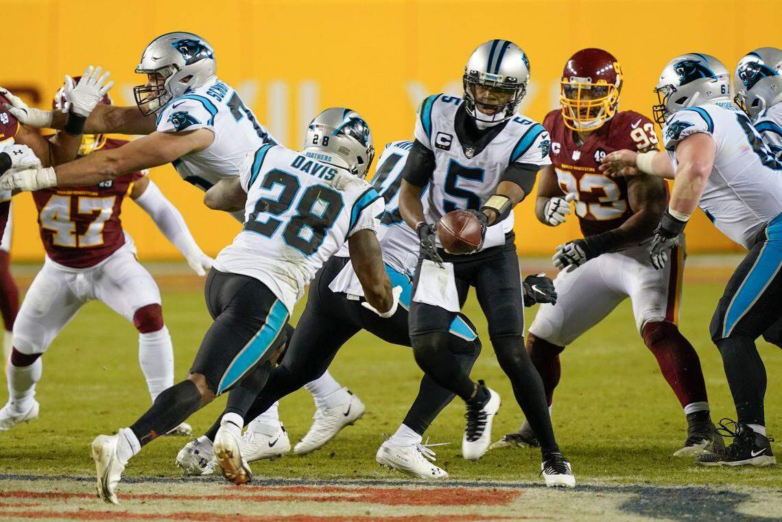 Carolina quarterback Teddy Bridgewater (5) hands the ball off to running back Mike Davis (28) during the second half the Panthers’ 20-13 win Sunday. Said Davis later: “We don’t care about draft picks. At the end of the day, our job is to perform.”