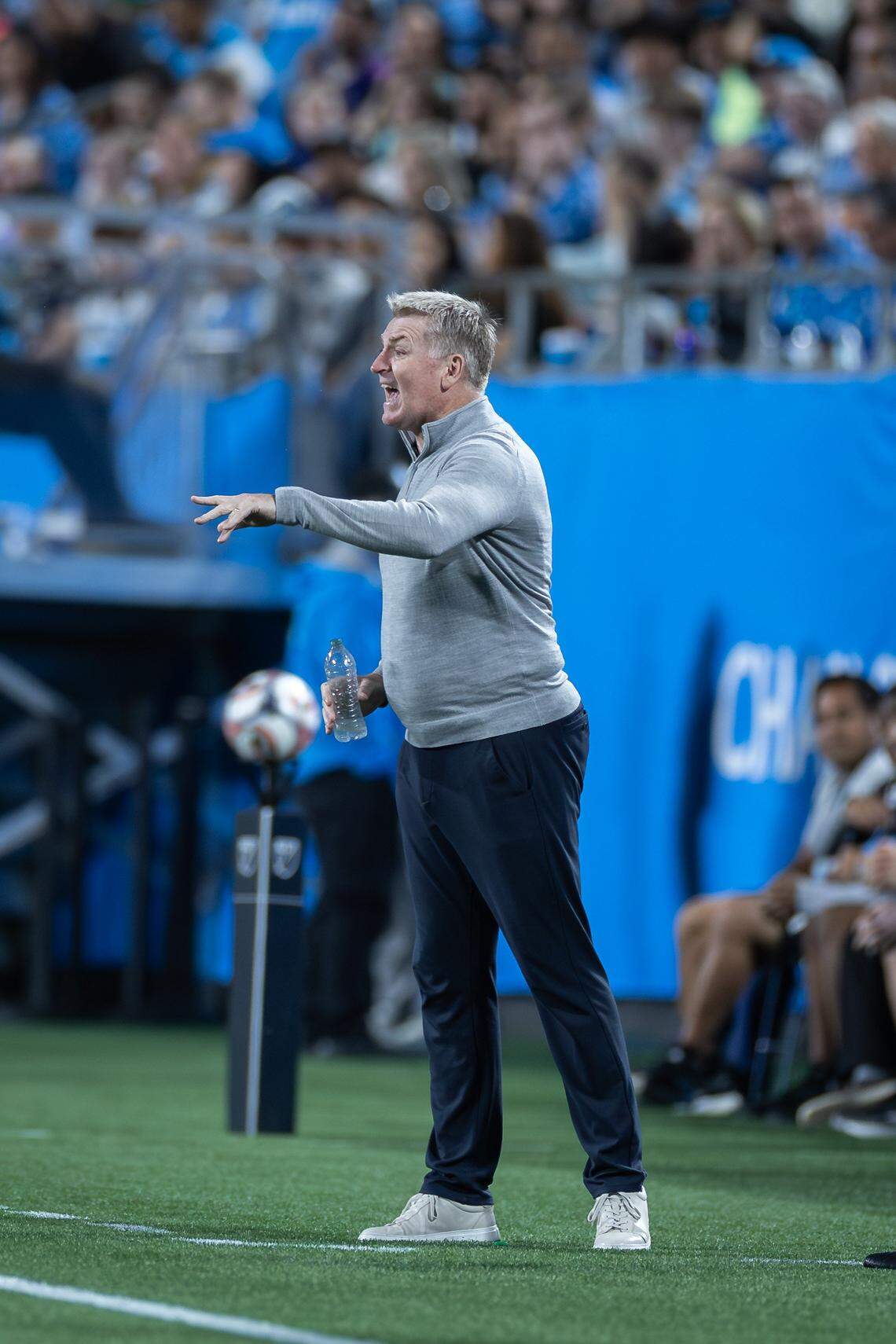 Charlotte FC head coach Dean Smith (center) calls out instructions to his players. Charlotte FC would win their home opener against Austin 3-1 Saturday March 7, 2026.