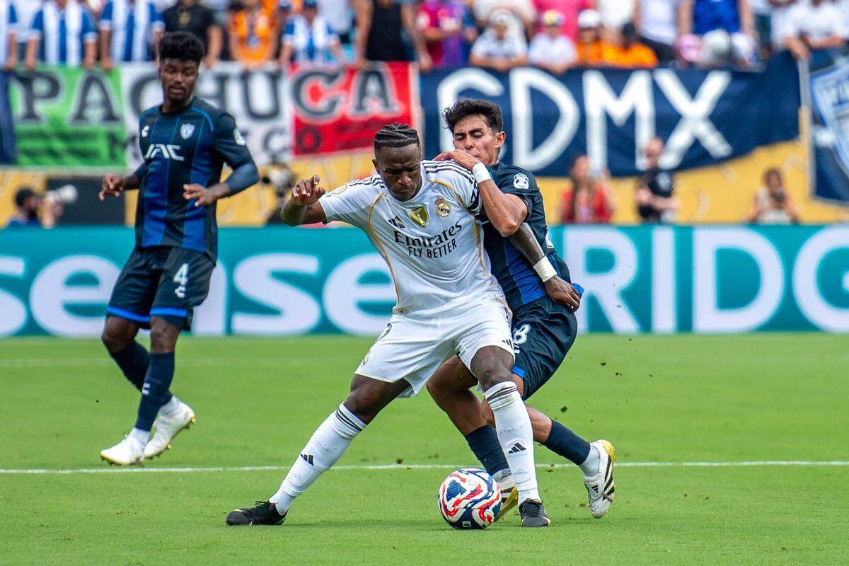Vinicius Oliveira Jr. dribbles the ball away from a Pachuca defender during the FIFA Club World Cup game between Real Madrid and Pachuca in Charlotte, NC, Sunday, June 22, 2025.