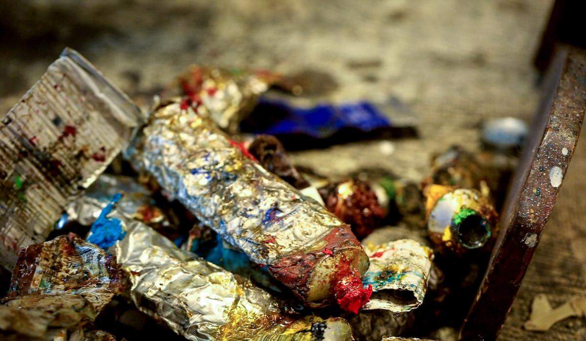 Tommie Robinson keeps some tubes of paint by his feet as he works so he can get to them more easily. Robinson's work ethic is admired. For decades he worked 7 days a week. At age 73, he only started taking Sundays off two years ago. 