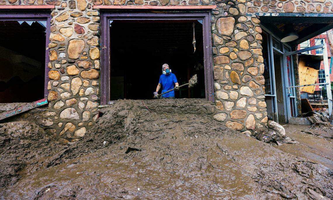 Ken Garrison of Marshall helps clean up downtown on Tuesday, Oct. 1, 2024 after the French Broad River caused catastrophic flooding. The remnants of Hurricane Helene caused widespread flooding, downed trees, and power outages in western North Carolina.