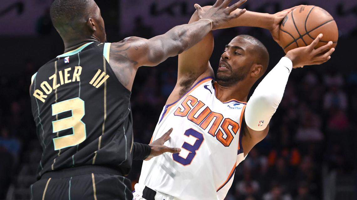 Charlotte Hornets guard Terry Rozier, left, applies defensive pressure on Phoenix Suns guard Chris Paul, right, during first quarter action at Spectrum Center in Charlotte, NC on Wednesday, February 1, 2023.