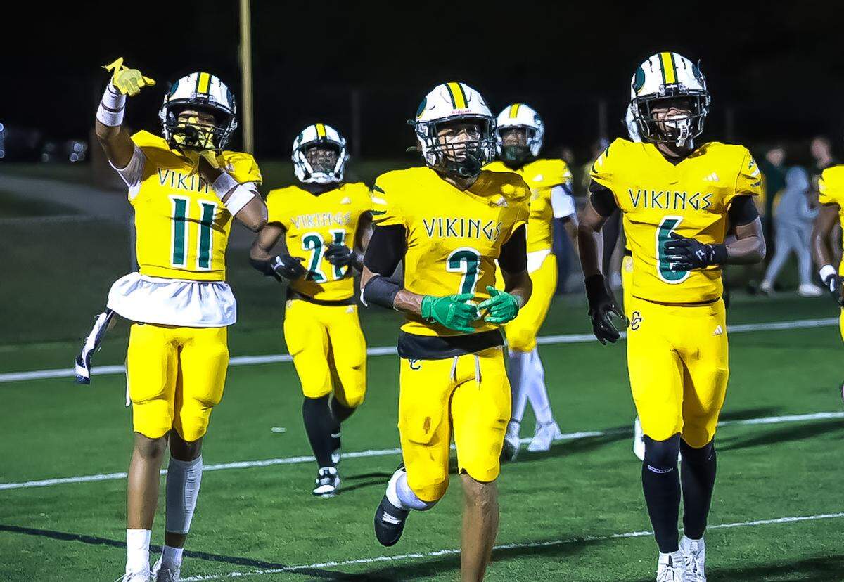 Central Cabarrus players run onto the field before a game against Olympic.